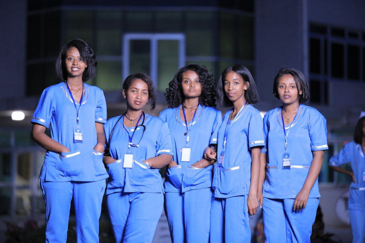Nurse attending to a patient in a hospital bed